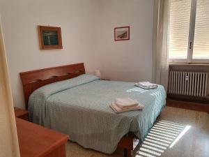 A bed or beds in a room at Central Sestri Executive BeachServices&HalfBoard