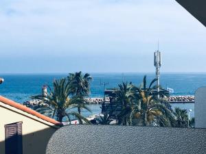 a view of the ocean from the balcony of a building at Gabriella in Menton