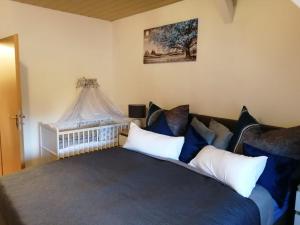 a bedroom with a bed with blue and white pillows at Ferienwohnung altes Steinlager in Oderberg