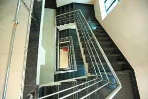 a spiral staircase in a building with a mirror at Railview inn Bhubaneswar in Bhubaneshwar
