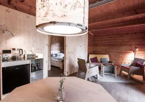 eine Küche und ein Wohnzimmer mit einem Tisch und einem Kronleuchter in der Unterkunft destinature Dorf Südeifel in Ernzen