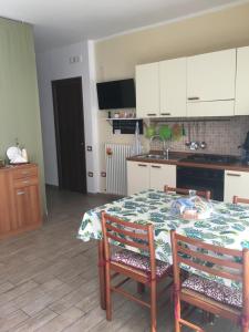kuchnia ze stołem z 2 krzesłami oraz kuchnia z białymi szafkami w obiekcie La Casa del Giglio w mieście Matera