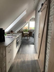 a kitchen with a door leading to a dining room at Meerblick 14 in Grömitz