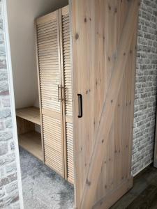 a wooden door in a room with a brick wall at Meerblick 14 in Grömitz