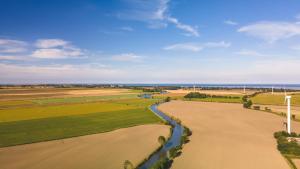 an aerial view of a field with a river at Landhaus-Altebrücke in Wangerland