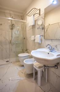 a bathroom with a sink and a toilet and a shower at Villa Royal B&B in Florence