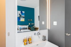 a bathroom with a sink and a mirror at Ambrosia Guesthouse in Rheinfelden