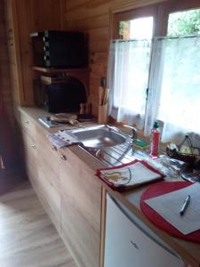 eine Küche mit einer Spüle und einer Arbeitsplatte in der Unterkunft Les Insolites de Nini in Grainville-Ymauville