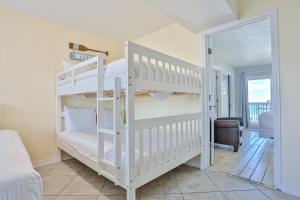 a bedroom with two bunk beds and a living room at Summer Haven D in Destin