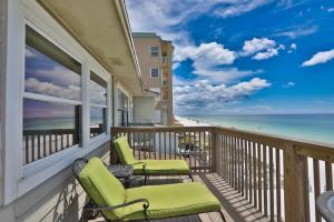 a balcony with chairs and a view of the beach at Summer Haven D in Destin
