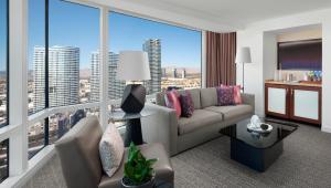 a living room with a couch and a large window at ARIA Resort & Casino in Las Vegas