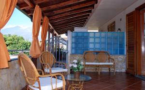 a patio with chairs and a table with a view at Appartamento Paradise in Fondachello