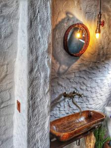 a bathroom with a wooden sink and a mirror at Căsuțele de sub Șipote in Porumbacu de Sus