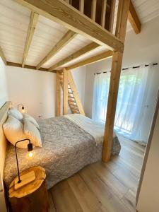 a bedroom with a bed in a room with wooden ceilings at Villa Alivu belle piscine chauffée in Bonifacio +47 photos