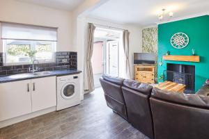 a living room with a couch and a sink and a fireplace at Host & Stay - Seagull Cottage in Bridlington