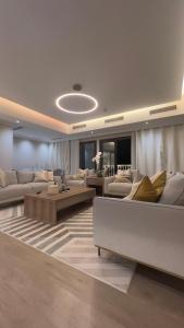 a large living room with couches and tables at The Key - Luxury Apartment in Doha