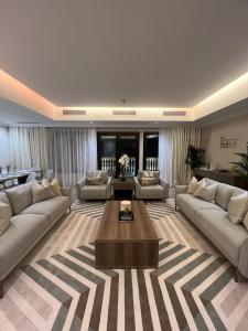 a large living room with couches and a coffee table at The Key - Luxury Apartment in Doha