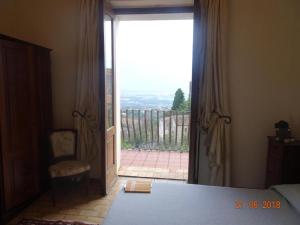 a bedroom with a large sliding glass door with a view at Castello di Altomonte in Altomonte