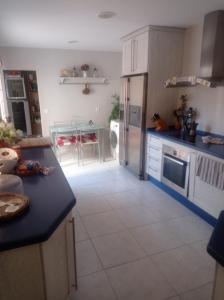 a kitchen with a refrigerator and a table in it at Berna in Jerez de la Frontera