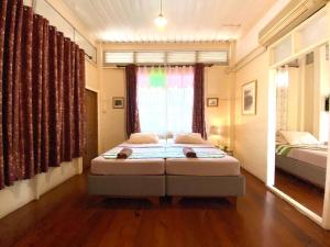 Postel nebo postele na pokoji v ubytování บ้านชมจันทร์