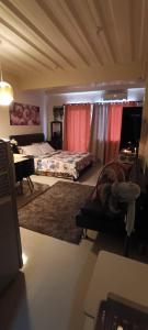 a bedroom with a bed and a desk with a desk at Katliza Condotel Kassel Residences in Manila