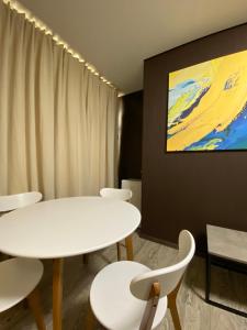 a meeting room with white tables and white chairs at Hotel Atmosphere in Poltava
