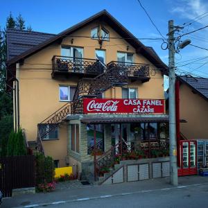 ブシュテニにあるCasa Fanelのコカコーラの看板が貼られた建物