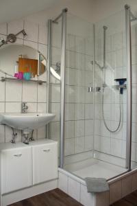 a bathroom with a sink and a shower at Ferienwohnung Ausblick in Willingen