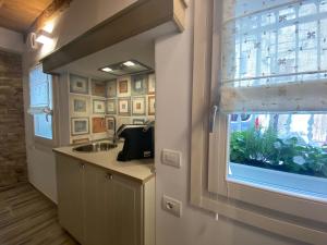a bathroom with a sink and a window with a plant at B&B InCalle in Chioggia +6 photos