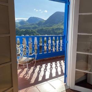 a door to a balcony with a view of mountains at HOTEL MONTANAS in Nova Friburgo
