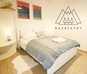 a bedroom with a bed with aania sign on the wall at Apartment BazaTatry Morskie Oko in Zakopane