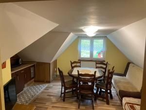 a dining room with a table and chairs at Apartments Ve dvoře in Velké Karlovice