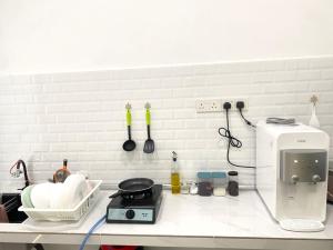 a kitchen with a counter top with a microwave and a counter top at HZ HOMESTAY PENDANG in Pendang +5 photos