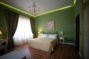 Postel nebo postele na pokoji v ubytování Hotel Villa Dorata