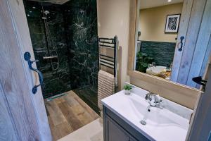 a bathroom with a sink and a shower at Stable Barn 