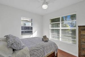 um quarto com uma cama e duas janelas em Beautiful 4 Bedrooms/Pool/Walk to beach em Deerfield Beach