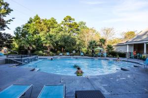 a large swimming pool with two people in it at Lux 2BD 2BA minutes from the water in Pensacola