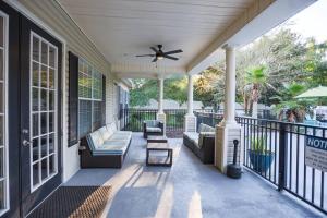 a porch of a house with a ceiling fan at Lux 2BD 2BA minutes from the water in Pensacola