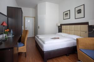 Postel nebo postele na pokoji v ubytování Hotel Minerva