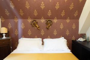 Postel nebo postele na pokoji v ubytování Hotel Villa Dorata