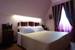 Postel nebo postele na pokoji v ubytování Hotel Villa Dorata
