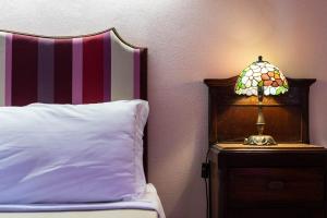 Postel nebo postele na pokoji v ubytování Hotel Villa Dorata