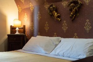 Postel nebo postele na pokoji v ubytování Hotel Villa Dorata