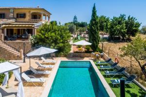 a villa with a swimming pool and a house at Ideal Property Mallorca - Puig d'en Guardiola in Moscari