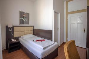 Postel nebo postele na pokoji v ubytování Hotel Minerva