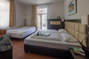 Postel nebo postele na pokoji v ubytování Hotel Minerva