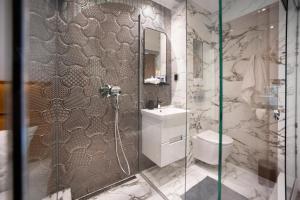 a bathroom with a shower and a toilet and a sink at CenterMini Rooms with Parking - Best Location & Value in Belgrade