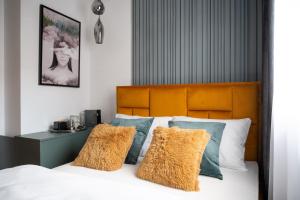 a bedroom with a bed with blue and white pillows at CenterMini Rooms with Parking - Best Location & Value in Belgrade