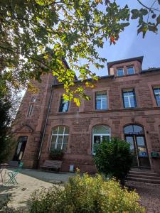 a brick building with a bench in front of it at Ancienne Gare 1er étage in Wasselonne