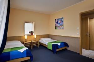 Postel nebo postele na pokoji v ubytování Jagelló Business Hotel
